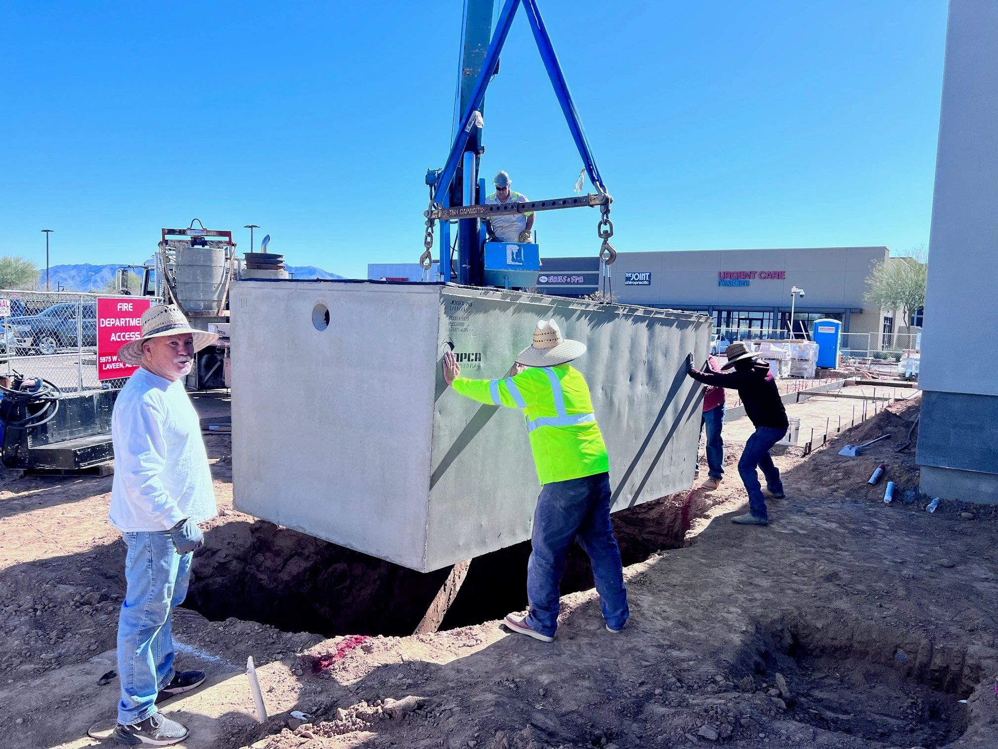 Concrete utility installation with crane